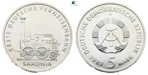 Deutschland 5 Mark 1988 A "Ferneisenbahn Saxonia" auf der Auktion Savoca Numismatik  - 12. Juli 2025
